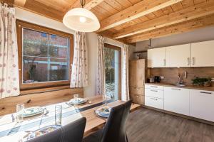 a kitchen and dining room with a table and chairs at Ferienwohnung Rupertiwinkl in Teisendorf