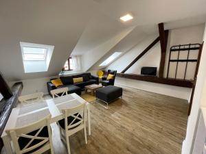 a living room with a couch and a table at Apartmán U Hradeb Tachov in Tachov