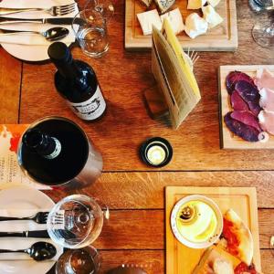 a wooden table topped with plates of food and wine at The Plume of Feathers in Sherborne