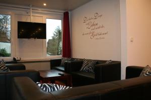 a waiting room with leather couches and a window at Haus-Maria-Magdalena in Bad Lauterberg