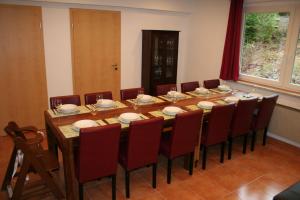 a conference room with a large wooden table and chairs at Haus-Maria-Magdalena in Bad Lauterberg