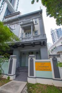 a building with a yellow sign in front of it at Cantonment Serviced Apartment in Singapore