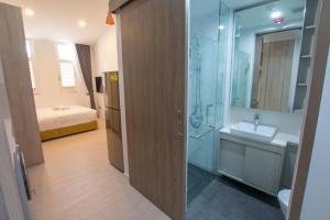 Cantonment Serviced Apartment في سنغافورة: حمام مع حوض ودش ومغسلة