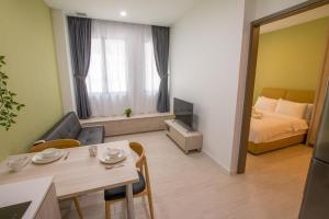 a small living room with a bed and a table at Cantonment Serviced Apartment in Singapore