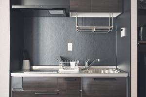 a kitchen with a sink and a counter top at ReLA Higashimatsudo in Matsudo