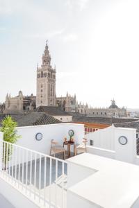 a white balcony with a view of a building at U-Sense Sevilla Catedral in Seville