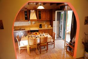 a kitchen with a table and chairs and an archway at Stefanias Appartments in Ágios Matthaíos
