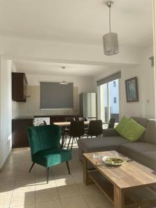 ein Wohnzimmer mit einem Sofa und einem Tisch in der Unterkunft Cosy apartment in Kato Paphos with pool access in Paphos City