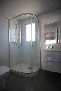 a glass shower in a bathroom with a toilet at 0705 Ap Victoria I in Denia