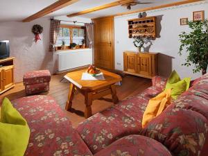 a living room with a couch and a table at Haus Michinglehen in Marktschellenberg +7 photos