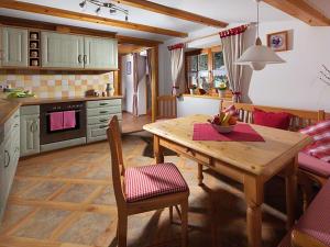 a kitchen with a wooden table and a dining room at Haus Michinglehen in Marktschellenberg