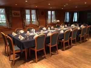 a conference room with a long table and chairs at Hotel Löwen in Escholzmatt