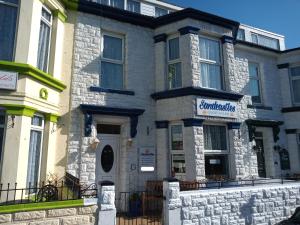 a large stone building with a sign on it at Sandcastles Guest House in Great Yarmouth