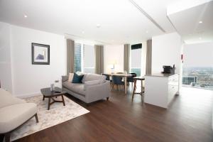 a living room with a couch and a table at Canary Wharf by Charles Hope in London