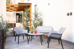 a patio with chairs and a table and a table at Etna Hills in Catania