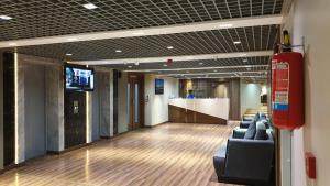 a lobby with couches and a tv in a building at Morvee Hotels Durgapur in Durgāpur