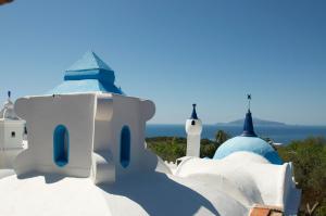 a group of white buildings with blue domes at Villa Eva in Anacapri