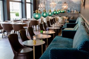 a row of tables and chairs in a restaurant at Motel One München Sendlinger Tor in Munich