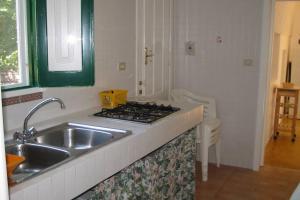 a kitchen with a sink and a stove at Casa Colonica in Gallipoli +23 photos
