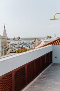 a view of the ocean from the balcony of a building at THE MODERNIST, Architecture experience in Faro