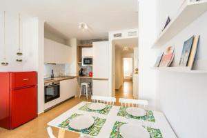 a kitchen with a dining table and a red refrigerator at Trendy Homes Almería in Almería