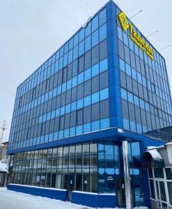 a blue building with a yellow sign on it at Гостиница "Талисман" in Barnaul
