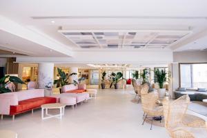 a waiting room with couches and chairs at Hotel Cristina by Tigotan Las Palmas - Adults Only in Las Palmas de Gran Canaria