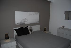 a bedroom with a large bed with two night stands at Focu e Mari in Mascali