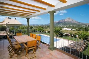 a patio with a table and chairs and a view of the mountains at 0338 Villa Elefante Tia in Jávea