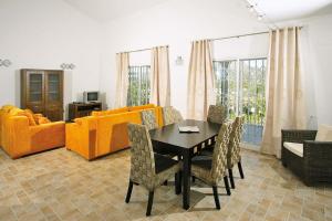 a living room with a table and orange furniture at 0338 Villa Elefante Tia in Jávea