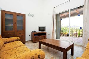 a living room with a couch and a table and a tv at 0338 Villa Elefante Tia in Jávea