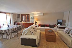 a living room with a couch and a table at Marbat in Port de Soller