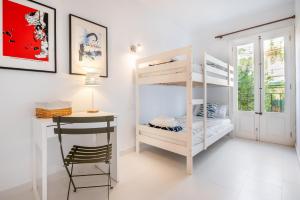 a room with a bunk bed and a desk at Casa Sunny in Port de Soller