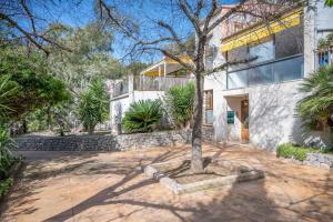 a house with a tree in the middle of a driveway at Casa Sunny in Port de Soller