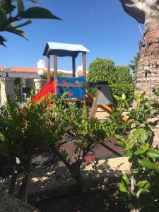 a playground in a park with a play structure at WiFi Costa Adeje in Adeje