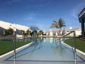 a swimming pool with clear water in a building at WiFi Costa Adeje in Adeje