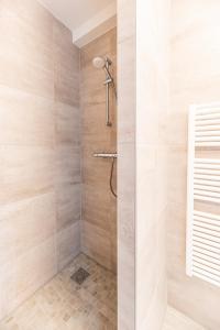 a bathroom with a shower with a glass door at Boutique Resort Schaardijk vakantiewoning in Scharendijke