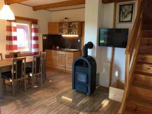 a kitchen and living room with a stove in a room at Chata Thurmberg in Vyšší Brod