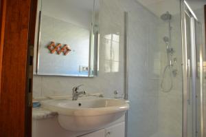 a white bathroom with a sink and a shower at Villetta con giardino in contesto riservato non lontana dal mare BEL01 in Agrustos +36 photos