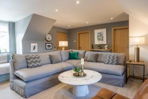 a living room with a couch and a table at No1 St Andrews - St Mary's Place in St Andrews