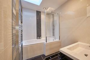 a bathroom with a shower and a tub and a sink at Host & Stay - Rosedale House in Richmond