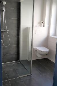 a bathroom with a shower and a toilet at Landhaus Braband Studios - Rugenbargsweg 17 in Cuxhaven