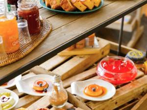 a table with plates of food and drinks on it at Novotel Porto Gaia in Vila Nova de Gaia