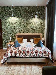 a bedroom with a bed with a floral bedspread at Dworek Zakopane in Zakopane