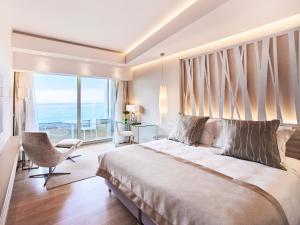 a bedroom with a large bed and a large window at ABAV2 Suites by Rodos Palace in Ixia +46 photos