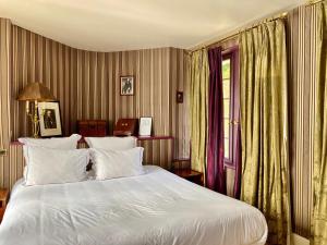 a bedroom with a white bed and a window at Domaine Saint Clair - Le Donjon in Étretat