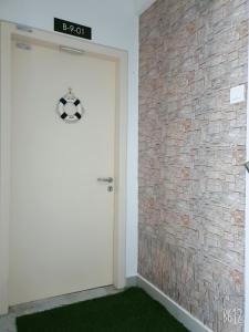 a door with a soccer ball on it next to a brick wall at Galleria Equine Park - Studio in Seri Kembangan