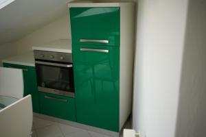 een groene kast in een keuken met een fornuis bij LA GHIBELLINA. confortevole,posizione privilegiata in Siena