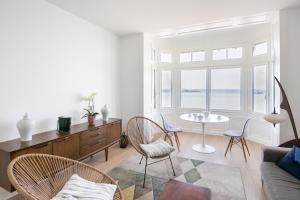 a living room with a table and chairs at La Perle Marine in Dinard