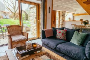 a living room with a couch and a table at Gîtes du Bulz, en pleine forêt proche de la mer in Pleyber-Christ